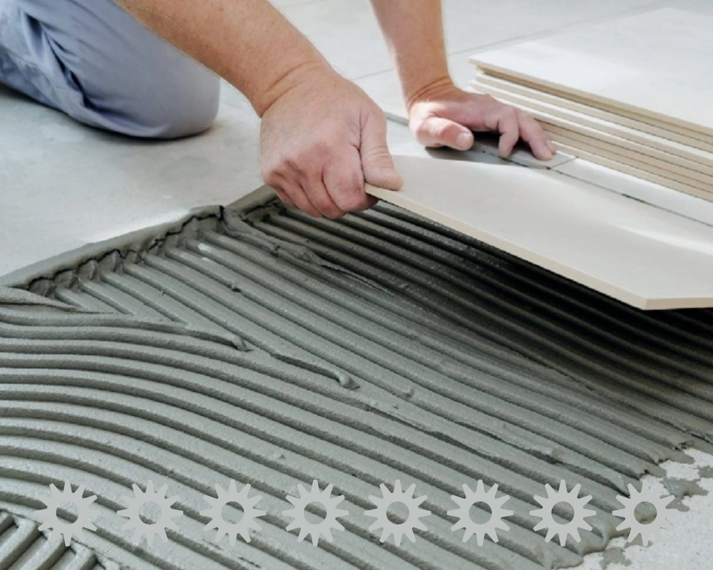 adhesive on tile applied using notched trowel for floor installation